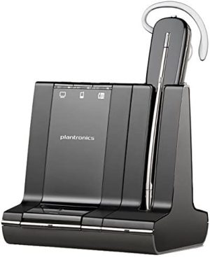 The S8240 SAVI 3-in-1 Convertible Headset UC DECT 6.0 NA features a sleek, modern black design and rests elegantly on its charging base. The base includes LED indicators and a slot for secure placement of the headset, which is equipped with a microphone boom and an ear hook to ensure it stays firmly in place on the user's ear.