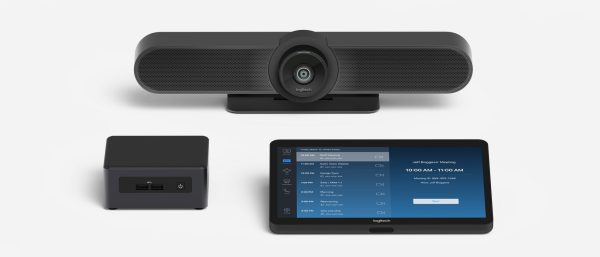 Image of a video conferencing setup featuring the Logitech Room Solutions for Zoom Rooms - Small, which includes a Logitech webcam, a mini desktop computer, and a touchscreen control panel displaying a meeting interface. The webcam is mounted on a stand, and the control panel shows a schedule for a meeting starting at 10:00 AM.
