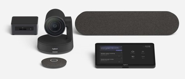 A conference room video setup featuring the Logitech Room Solutions for Microsoft Teams - Medium, which includes a sleek, modern PTZ camera, speaker, touchscreen control panel, microphone pod, and small connection hub in a sophisticated black and dark gray color scheme.