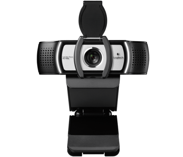 A front view of the PRO WEBCAM Ultra Wide Angle HD Webcam with a removable cover. The camera is black and silver with a lens in the center, flanked by microphones on each side. The base of the webcam is attached to a stand, likely designed for mounting on a monitor or other surface.